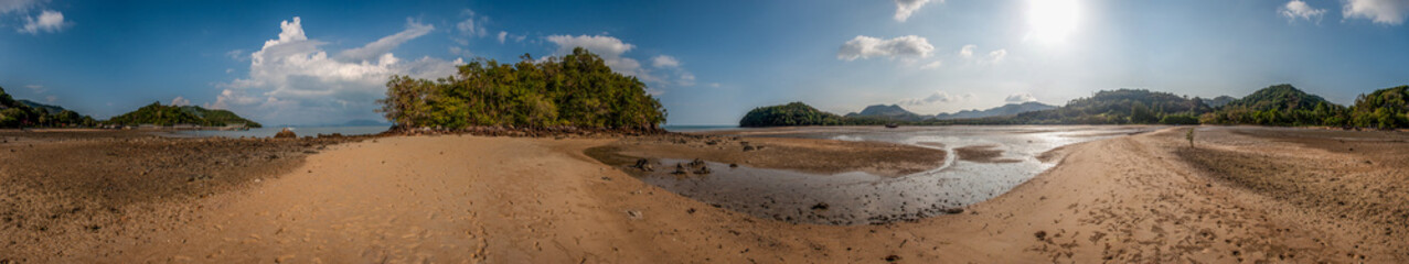 Full 360 degree equirectangular panorama of the coastline. Seascape at low tide. Sandspit to the...