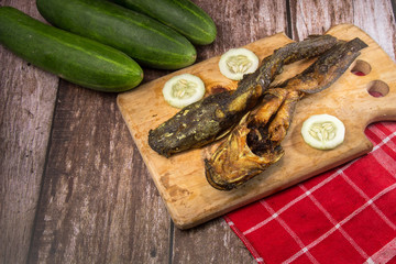 Deep fried catfish, on wooden background.