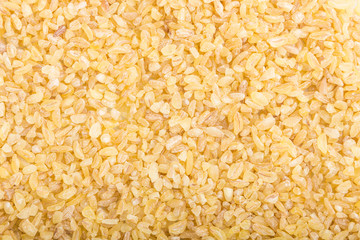 Texture of raw bulgur. Top view, close up, macro. Natural background.