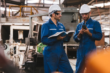 Group of industrial factory maintenance engineers inspect relay protection system using walkie...