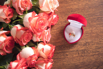 roses and ring on table