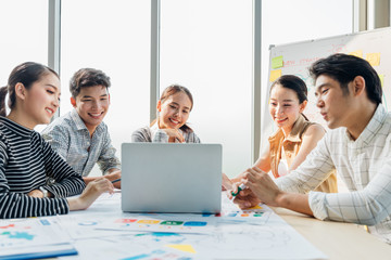 Group of asian young modern people in smart casual wear having a brainstorm meeting while sitting in office background. Business meeting, Planning, Strategy, New business development, Startup concept.