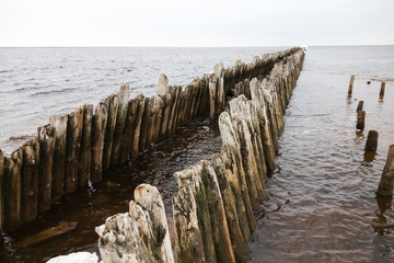 Fototapeta na wymiar a breakwater destroyed by time