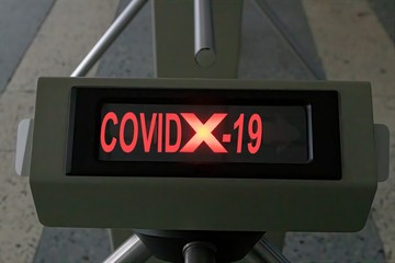 ''COVID X-19'' indication on a turnstile tripod screen