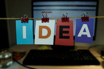 The word IDEA written on colorful note papers on board background. Idea concept.