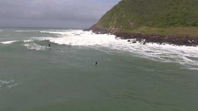 Surfer in a right hander of Silveira Beach, one of the main surf spots in Santa Catarina, Brazil