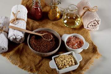 a bowl full of linseed in the company of other seeds for the production of homemade body cosmetics