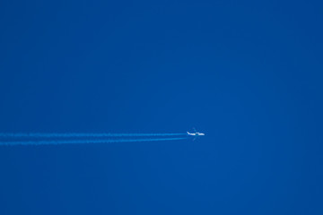 Fototapeta premium high in the blue sky flies a passenger jet