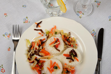 Vegetarian dish with white rice and vegetables on a white platethree piles of white rice with vegetables on a white plate as a side dish