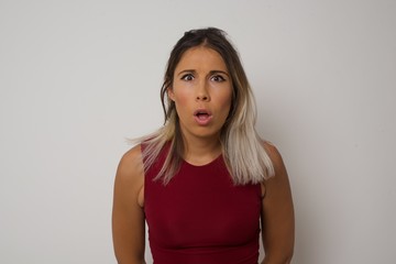 Obraz premium Attractive young woman having stunned and shocked look, with mouth open and jaw dropped, listening to friend's story in full disbelief, exclaiming: Wow, I can't believe this. Surprised girl. Shock