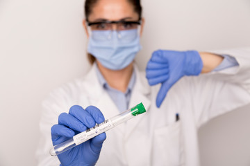 Positive Covid test in the hands of a nurse with blue gloves 