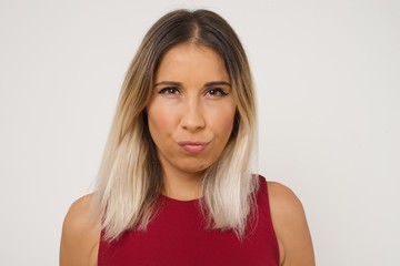 Fototapeta premium Portrait of outraged young woman with oval face, frowning her eyebrows being displeased with something.