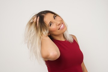Shot of happy young woman with positive smile, has long hair, rejoices having weekend and good rest after hard working exhausting week, isolated on gray wall.
