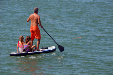 Three on a paddle board.
