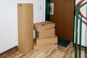 Stack of delivered packages in front of a door. Concept of goods delivery in lock down or quarantine time