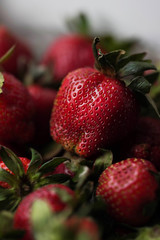 red strawberry berries on a light background close up