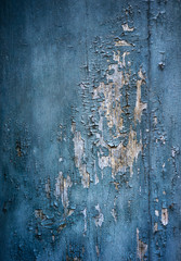 Paint is falling off the wooden door