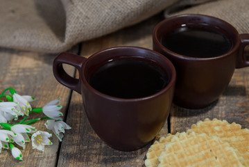 Coffee in a cup. Waffles. Snowdrops. Breakfast in bed