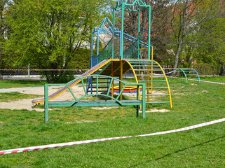 Obraz na płótnie Canvas A children 's playground enclosed with signal tape during the coronavirus epidemic COVID-19 in Russia. Kaliningrad