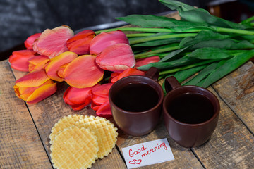 Coffee on a wooden table. Waffles are round. Breakfast