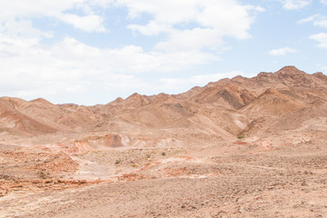 Fototapeta premium Desert, red mountains, rocks and cloudy sky. Egypt, color canyon.