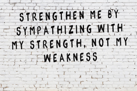 Black painted inscription of smart quote on white brick wall