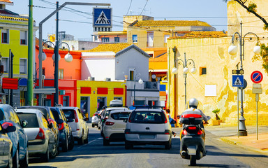 Street view on Road with cars and scooter in Cagliari reflex