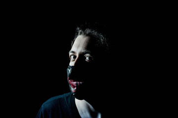 masked guy in the gloom