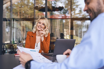 Merry woman looking at her business partner