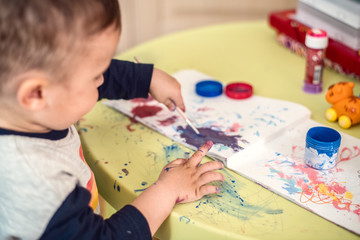 Child's hand painting with watercolor