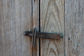 Background of weathered wood with hand forged latch closure, copy space, horizontal aspect