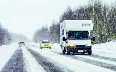 Obraz premium Caravan in road in Rovaniemi Finland of winter Lapland reflex