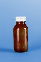 glass medicine bottle purple background