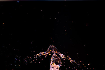 Obraz na płótnie Canvas High speed macro photography of a water drop splashing