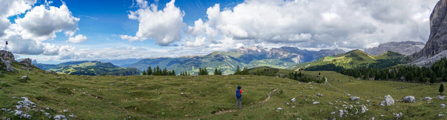 Fototapeta na wymiar Wonderful panoramic view: Young sporty hiker woman hiking in beautiful dolomite mountain scenery