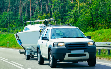 Car with boat in Car trailer in roadway Poland reflex