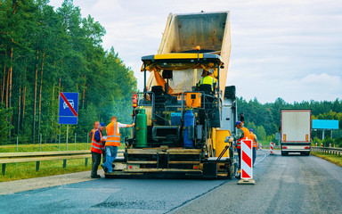 Road paving machine on road in Slovenia reflex