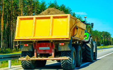 Tractor carrying sand Poland reflex