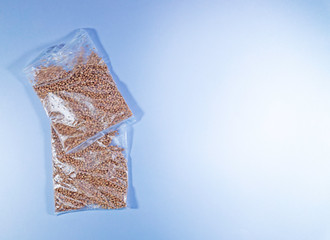 buckwheat in a transparent bag on white background