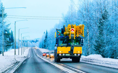 Lorry with lifting crane on road in winter Rovaniemi reflex