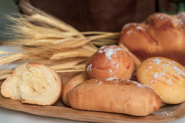 Baked breads on wooden table background.