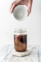 Pour shot of coffee and Almond Milk