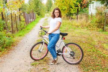 Young woman riding bicycle in summer city park outdoors. Active people. Hipster girl relax and...