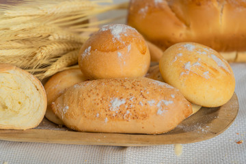 Baked breads on wooden table background.