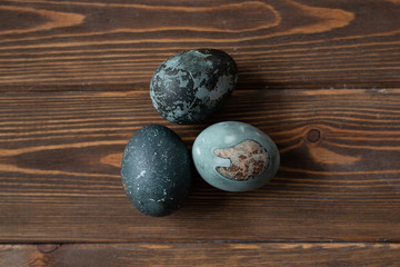 very beautiful eggs painted for easter lie on a brown wooden table