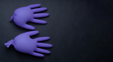 Pair of latex medical gloves on purple background. Protection concept. COVID-19. Epidemic background.  Quarantine background. Medical gloves for protection. Dangerous virus. gloves for test.copy space - obrazy, fototapety, plakaty