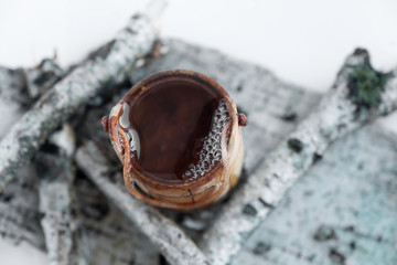 Naklejka premium Birch sap in a wooden bucket, on a white background. 