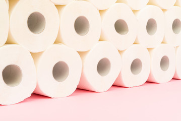 Image of toilet paper tower at pastel background.