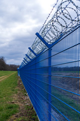 Fototapeta premium Prison barbed wire. Prison fence. Strict punishment for crimes