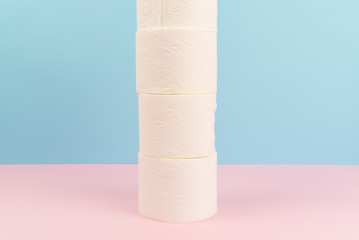 Conceptual image of toilet paper tower at pastel background.